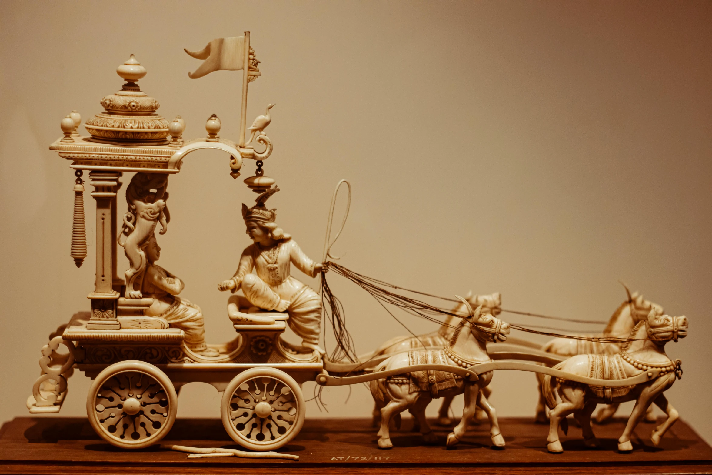 a sculpture of two horses pulling a cart