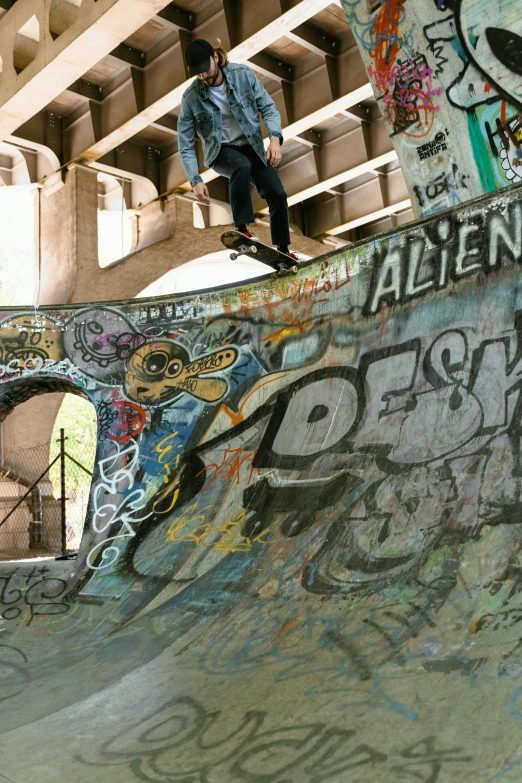 skateboarder with helmet grinding on ramp in skatepark