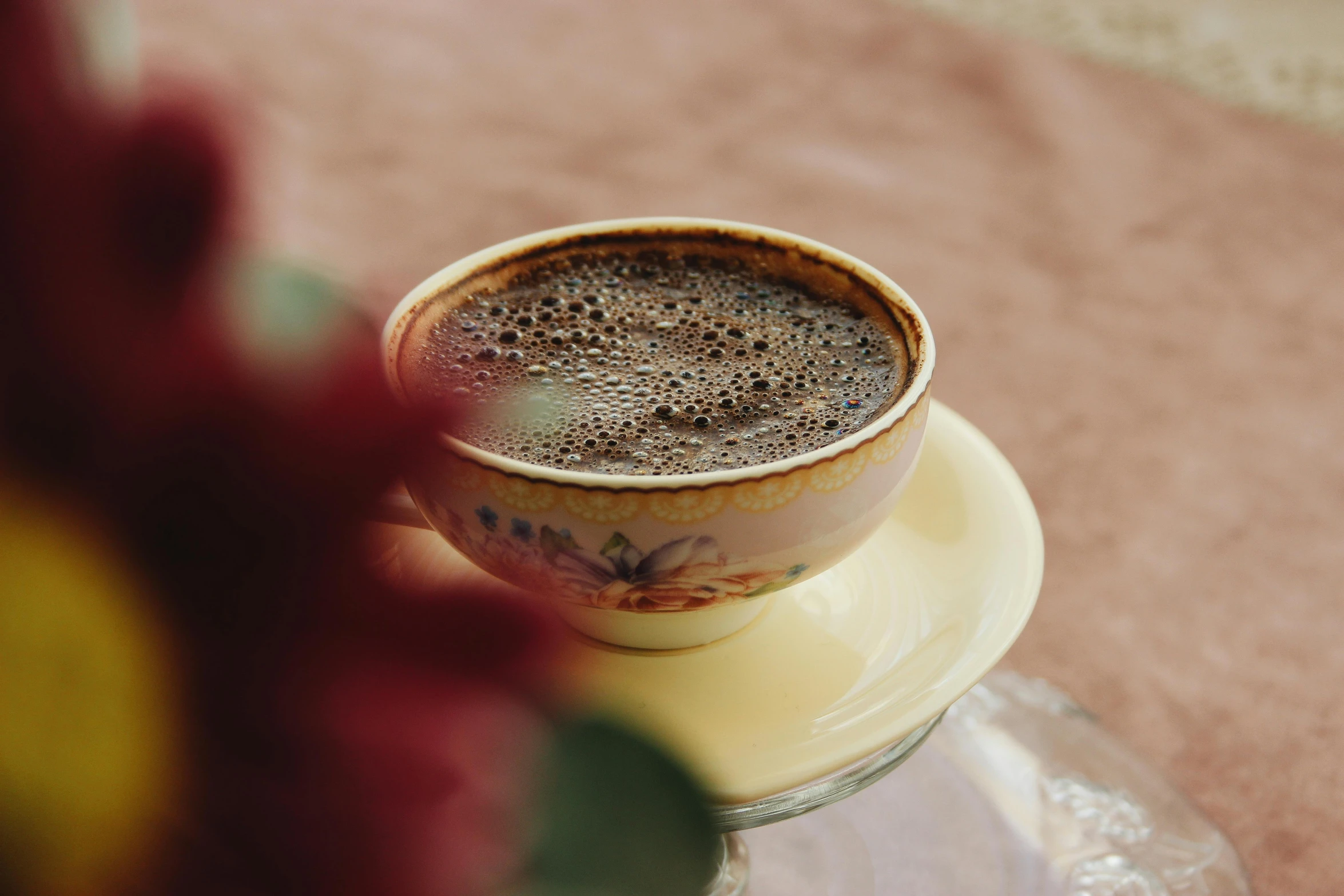 a cup of coffee is sitting on a small plate