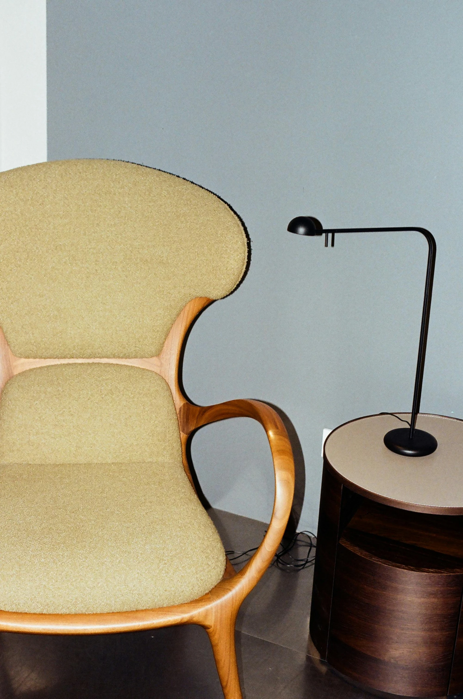 a chair and side table with a light on it