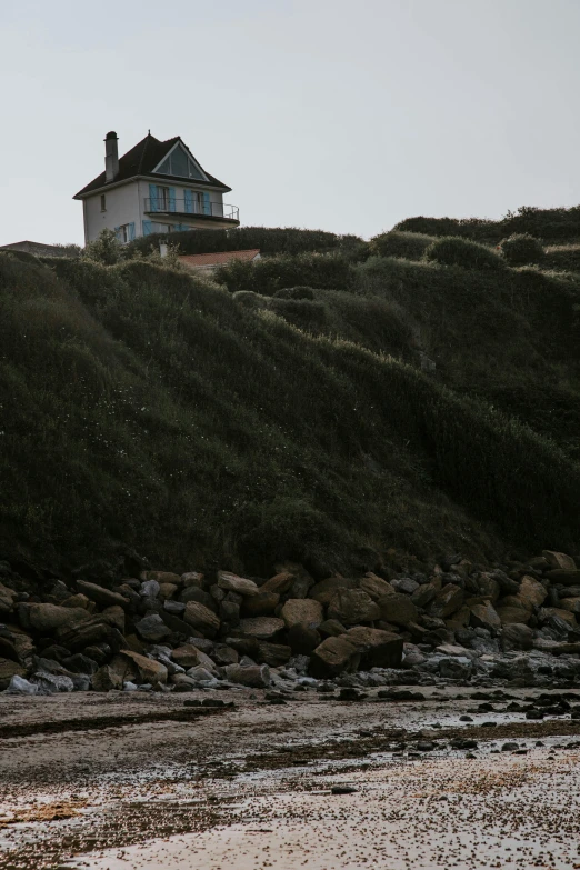 house sits on a hill above the beach