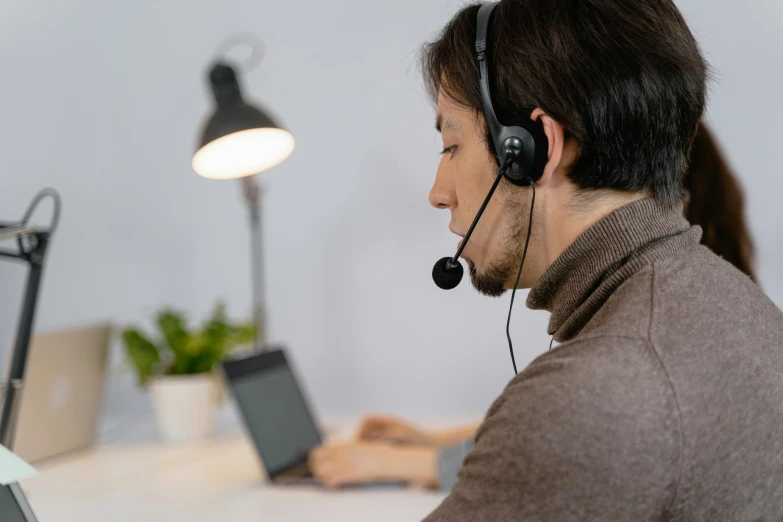 a man wearing a headset with two computers