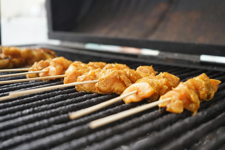 closeup of chicken skewers on a grill