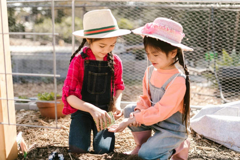 two children are playing in their small garden