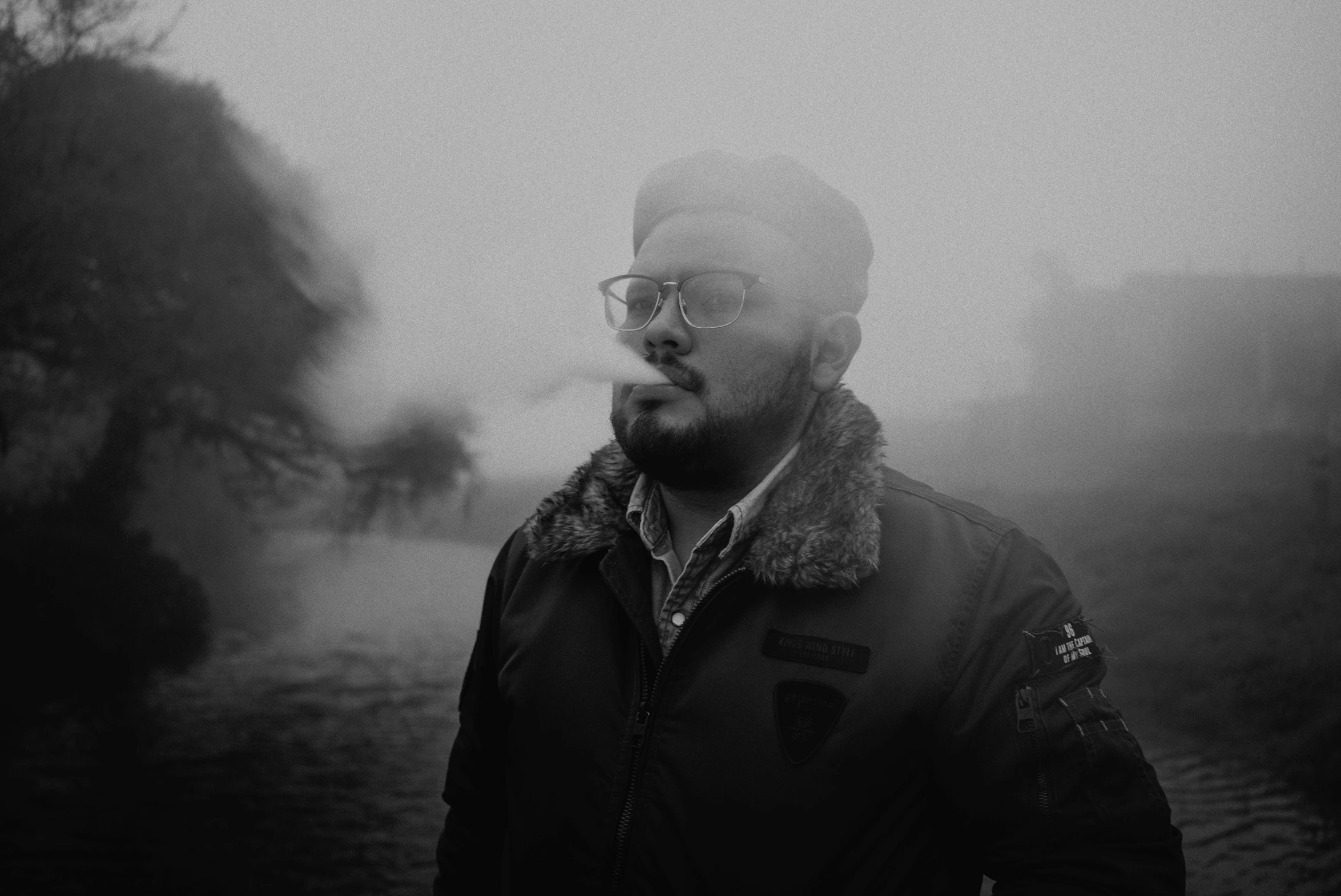 a man in black and white is smoking