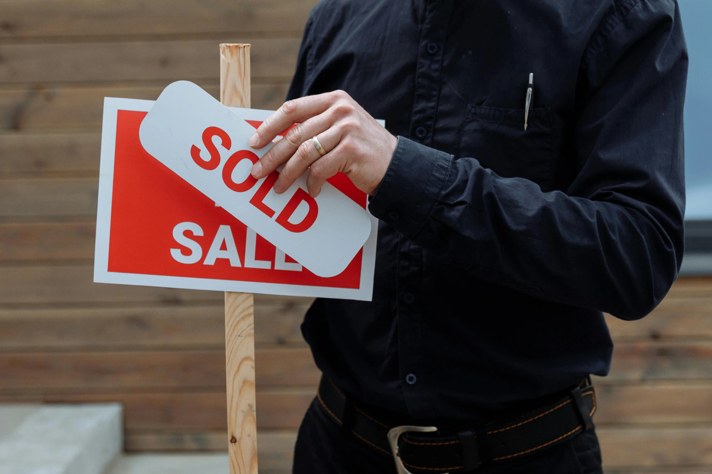 a person with a sold out sign attached to their shirt