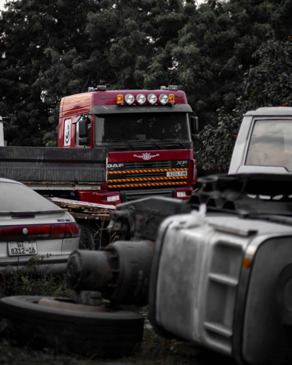 an old truck and a car sitting on the ground