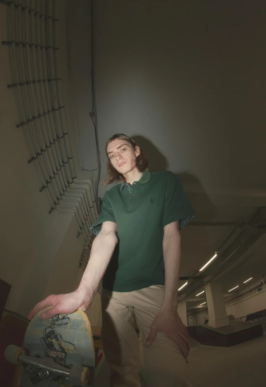 a teenage girl holding onto a skateboard in a room