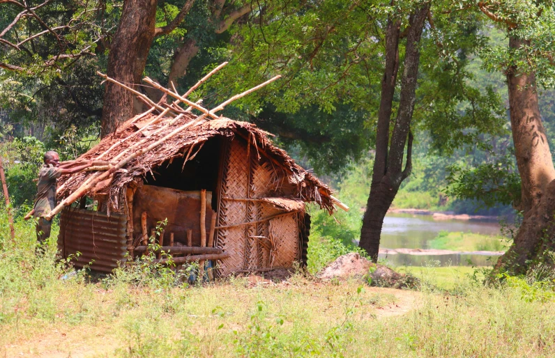 a very pretty building by the river in the woods