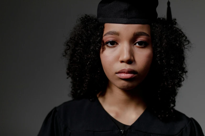 a woman wearing a cap with a fake graduation hat on her head