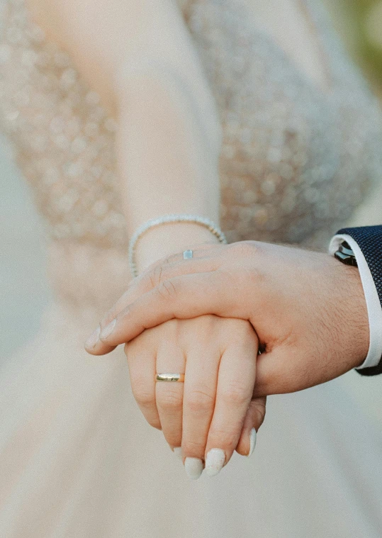 a close - up of a hand holding an engagement ring