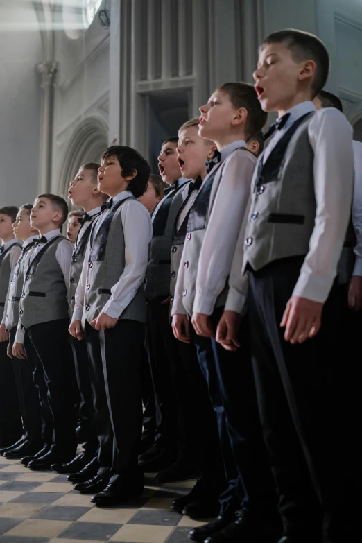 an image of children in uniform singing at choir