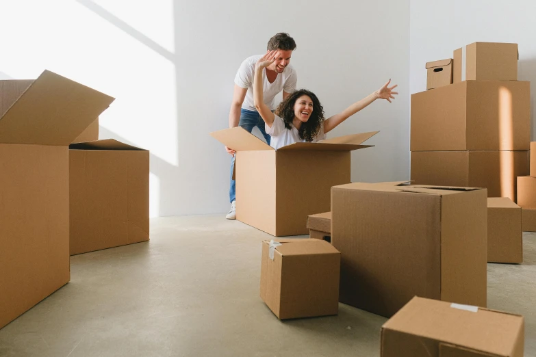 two people standing on top of a box