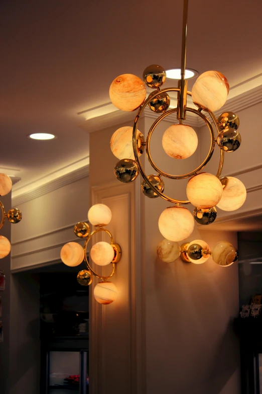 circular chandelier hanging in the middle of an elevator