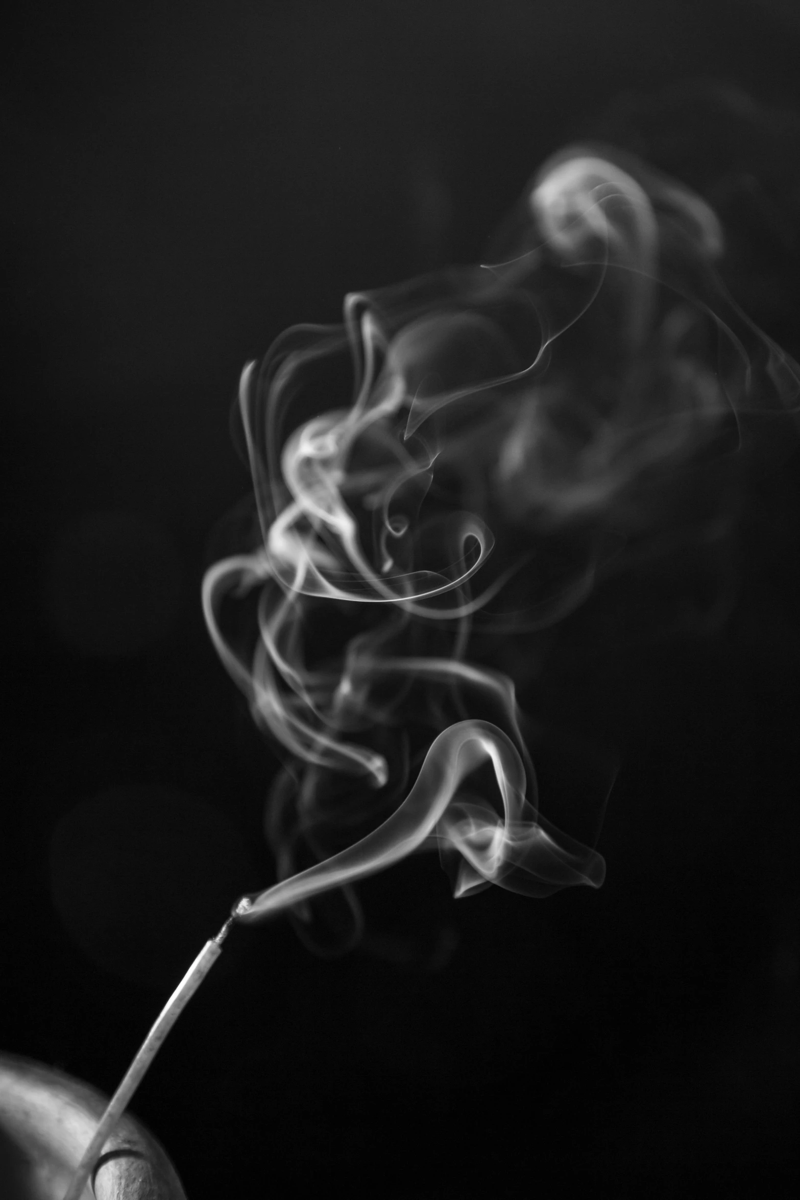 smoke billowing from the top of a stick