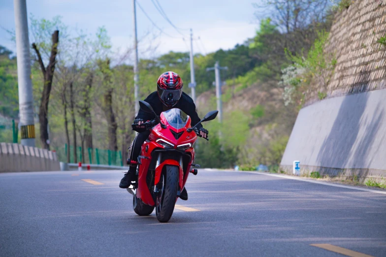 a person on a motorcycle riding down the road