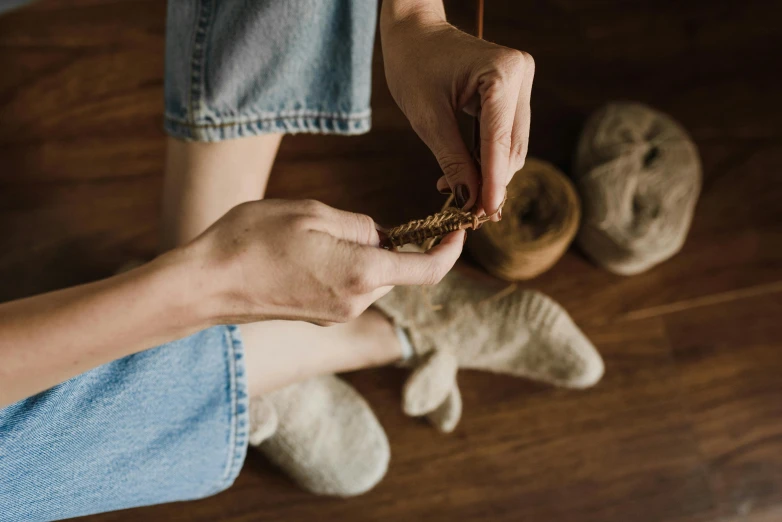 someone with their feet on the ground while sewing