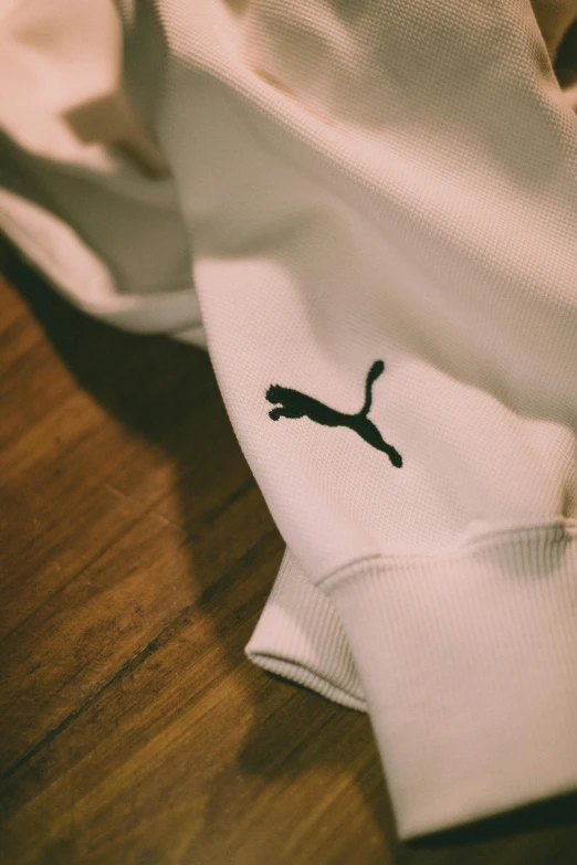 someone's puma logo on some white shirts