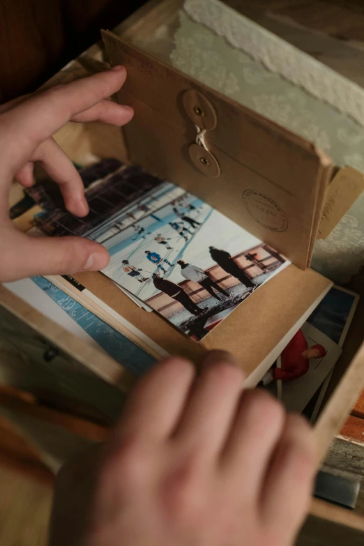 a person holding open a book near a stack of pos