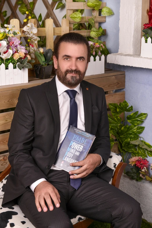 a bearded man with beard holding a book