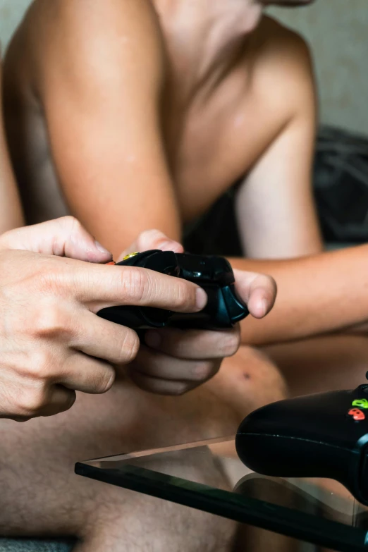 two people are sitting while playing video games