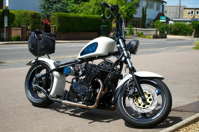 this is a white and blue motorcycle parked on a street