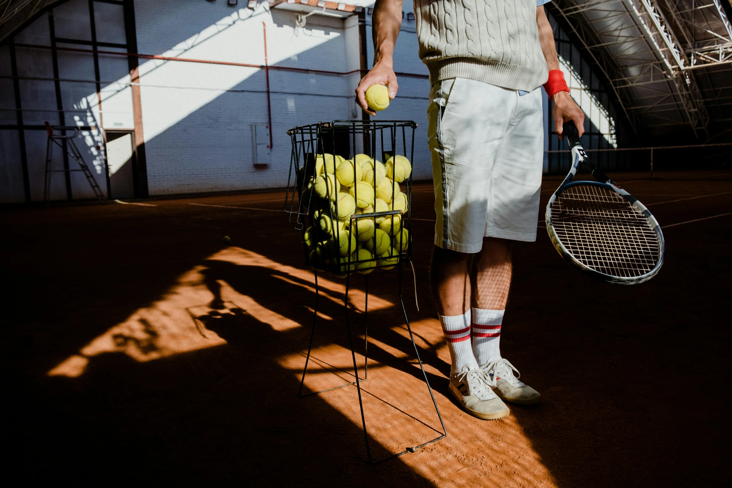 a tennis player holding a racket and balls