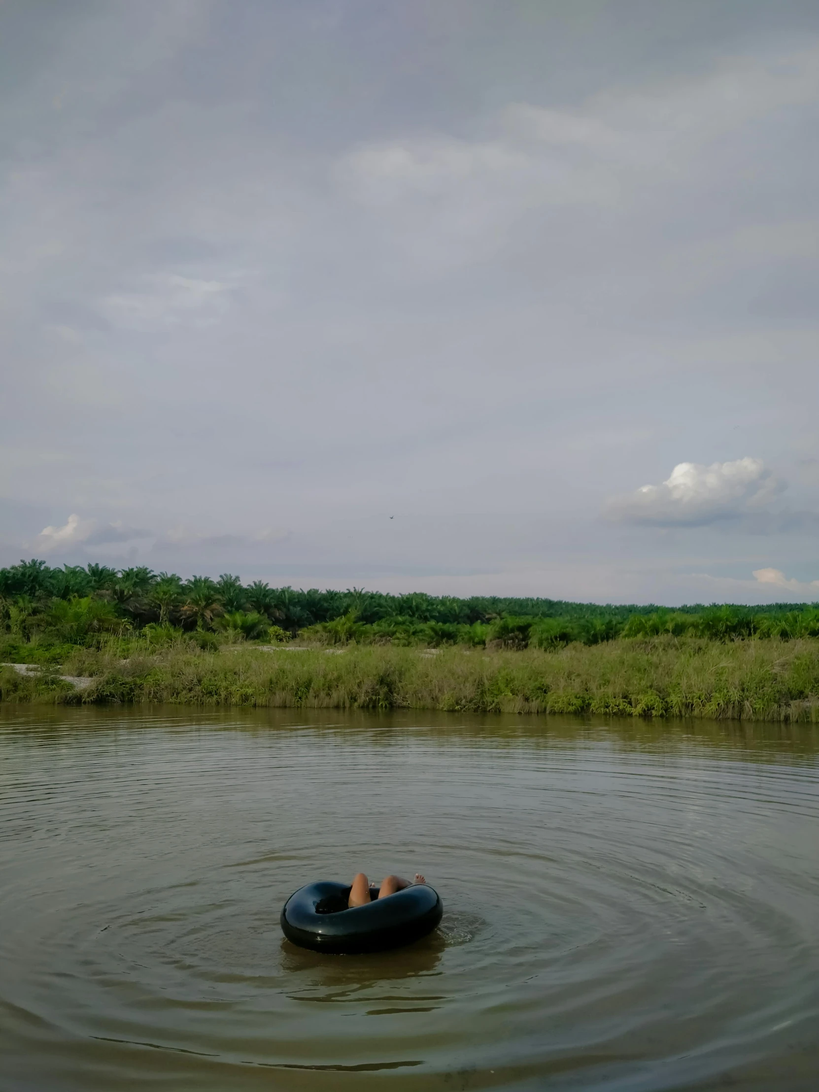 a couple floating on a rubber boat in a river