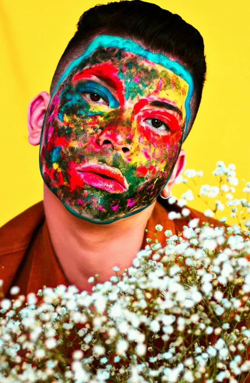 a man in an abstract portrait with a painted face behind the mask of a face