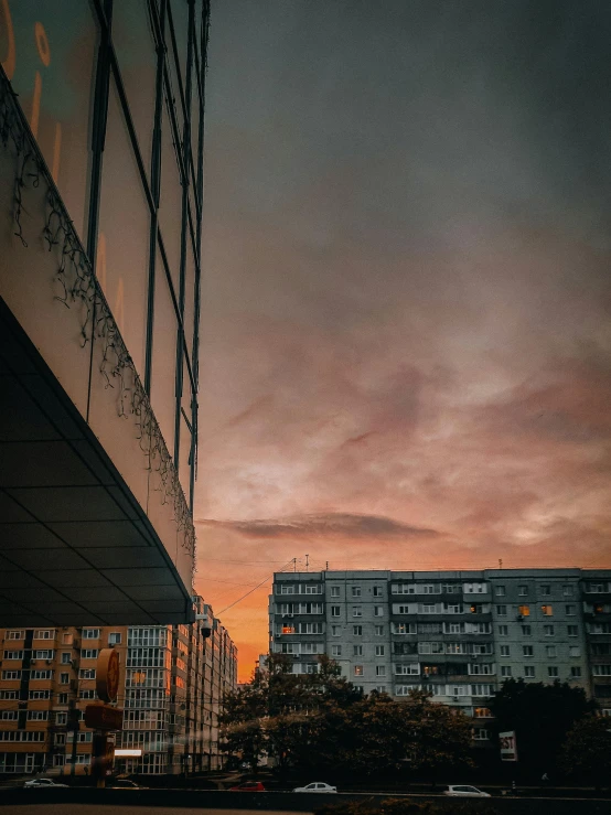 an old image of a sky at dusk from the street