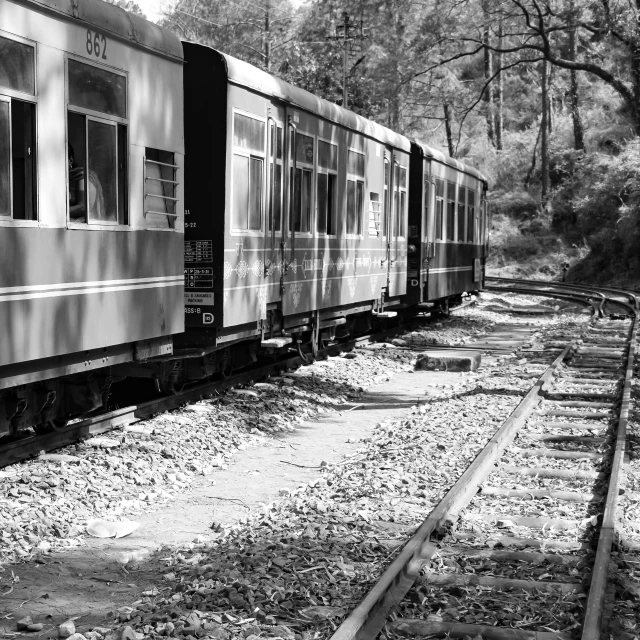 an old train car is parked at the tracks