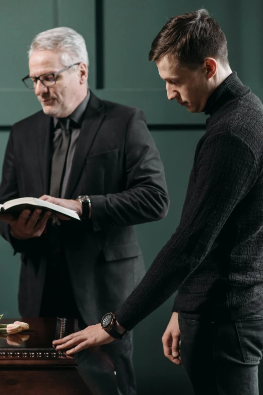 two men are checking soing on an old piano