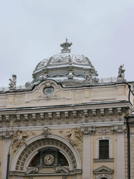 a building with intricate carvings and clock at the top