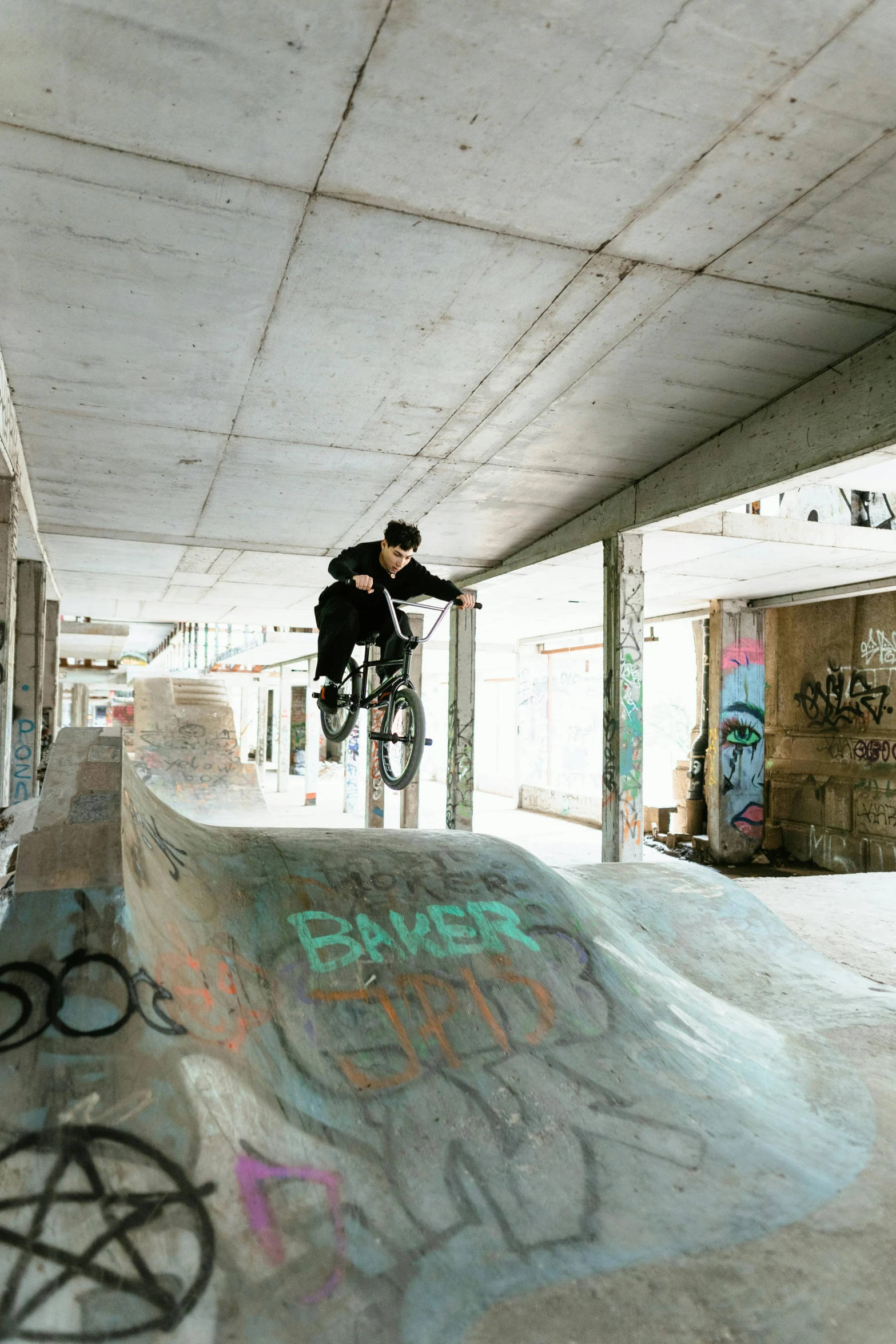 a boy on a skateboard jumping over a ramp