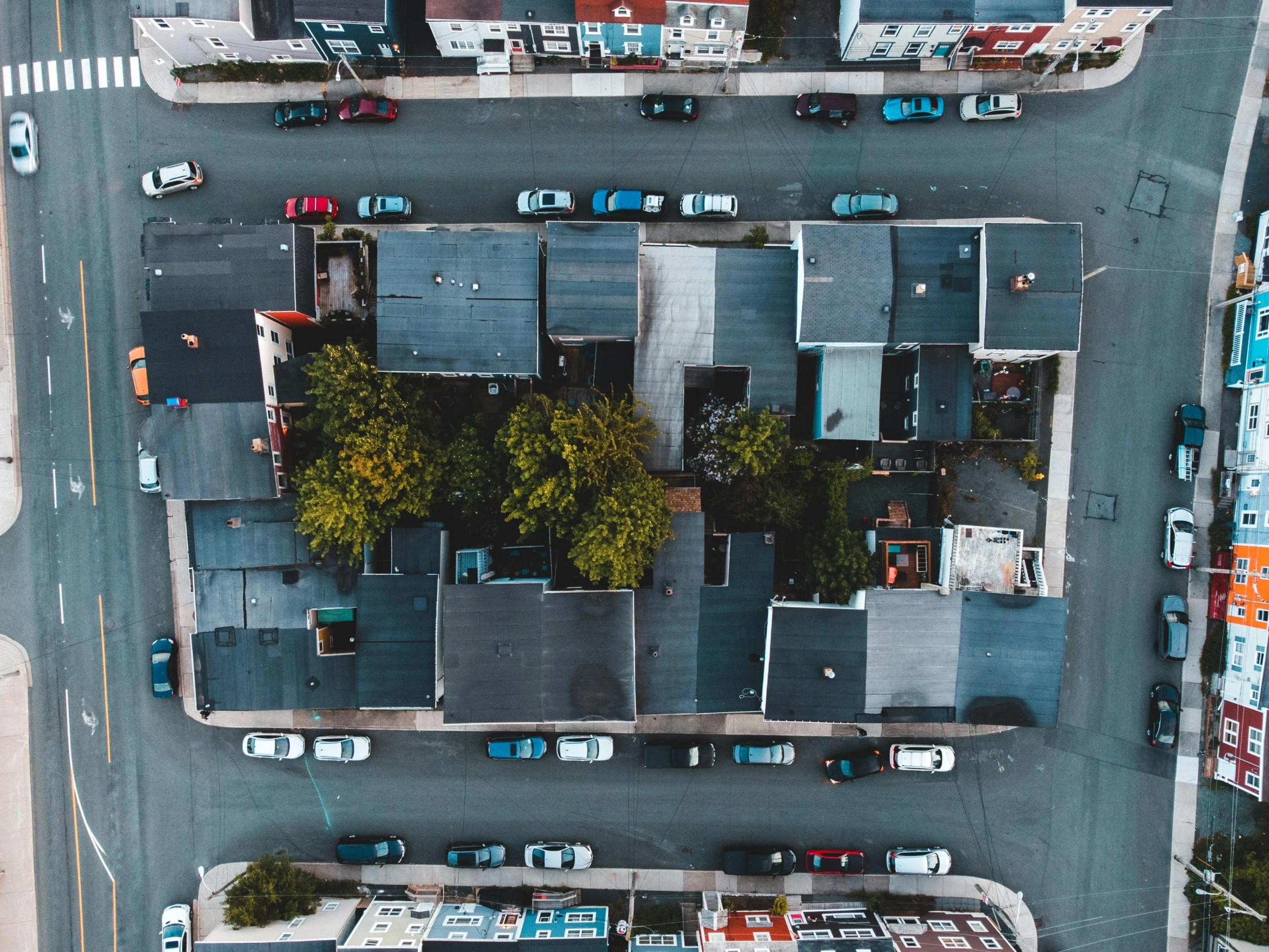 an aerial view of some buildings with cars