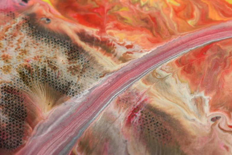 an abstract painting on a surface with pink and yellow colors