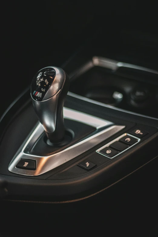 a gear stick in a vehicle with chrome trim