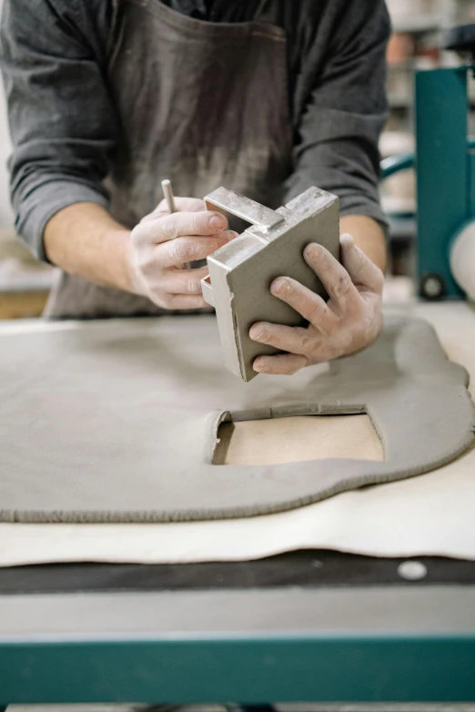 an image of a person working with clay