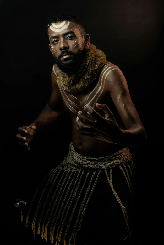 a black man with a beard and gold around his neck