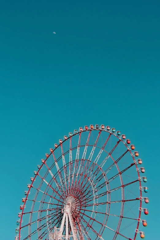 an amut park ferris wheel against a blue sky