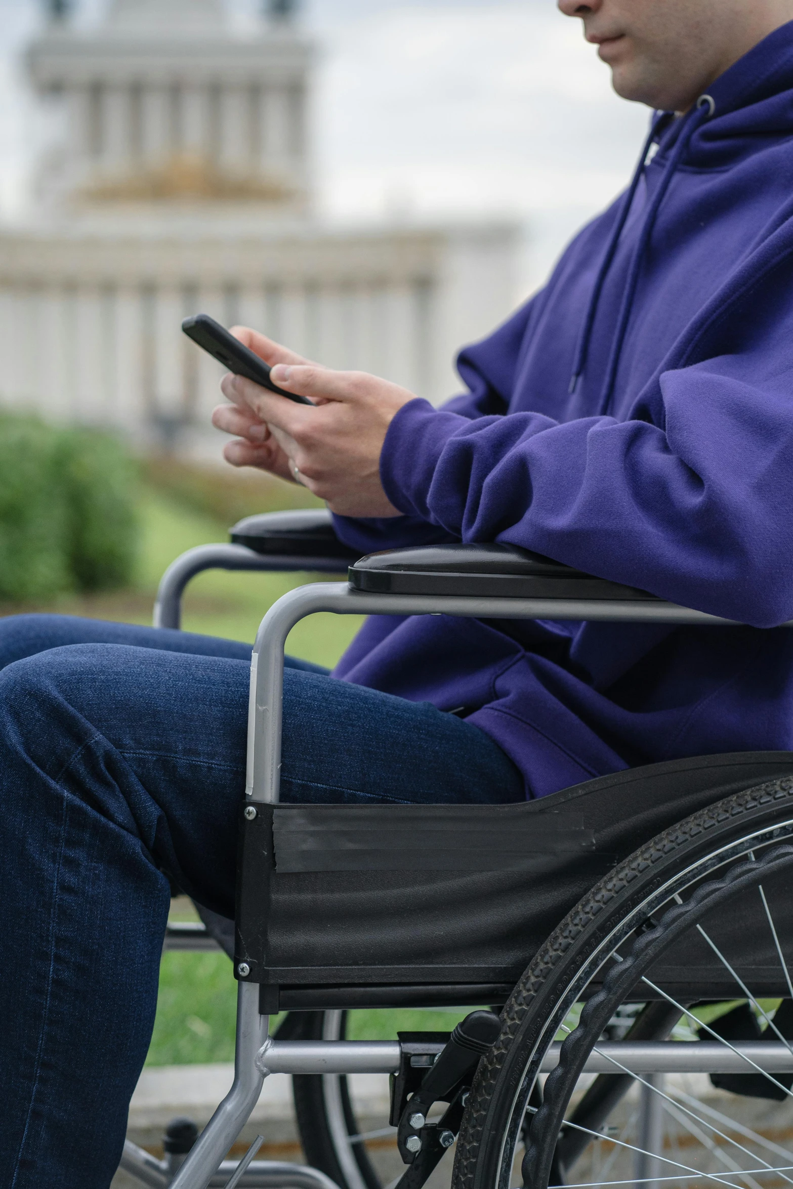 a man in a wheel chair holding a cell phone