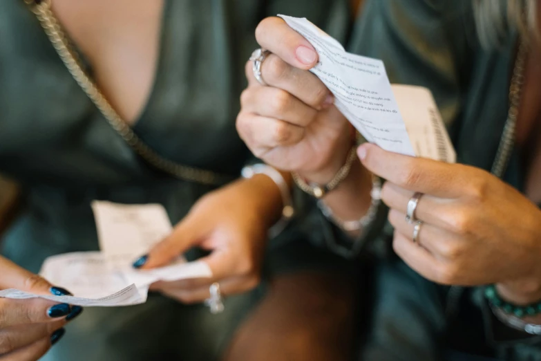 a woman is trying to open the paper envelope