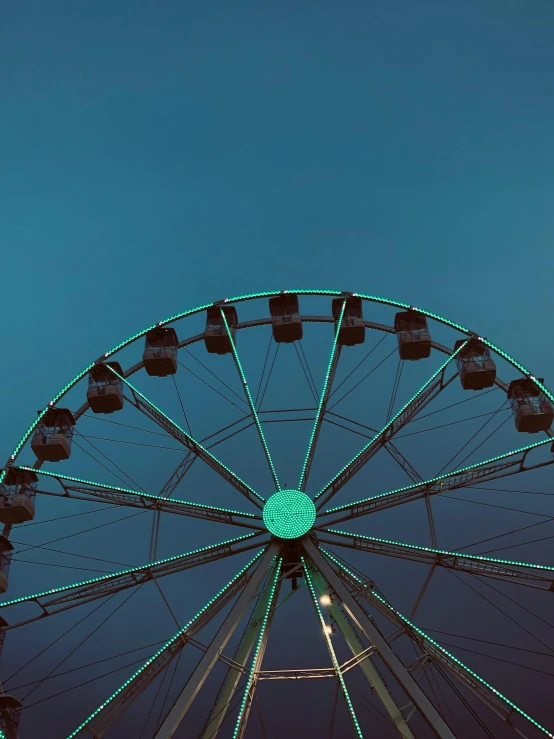 a ferris wheel at night with lights on