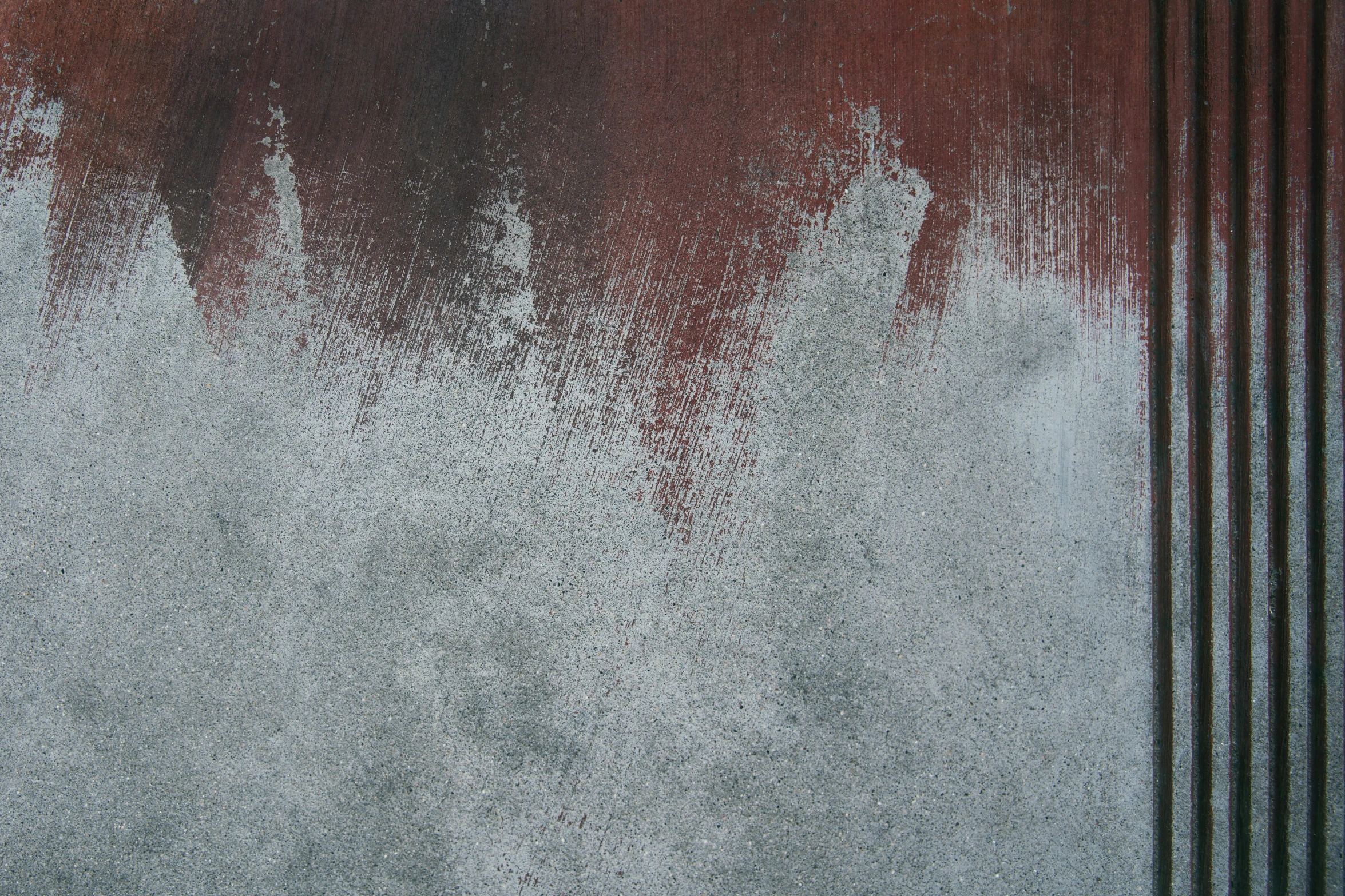 red and white wall next to a pole with a wooden fence