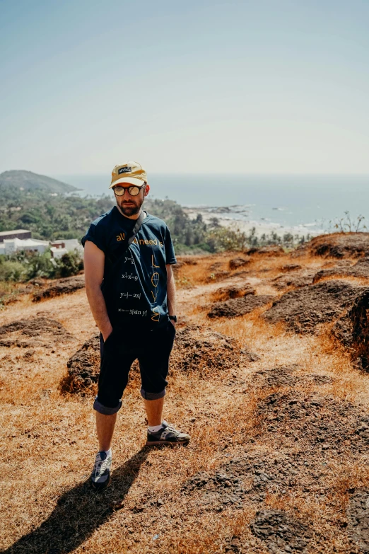 man in the field with the view on a mountain