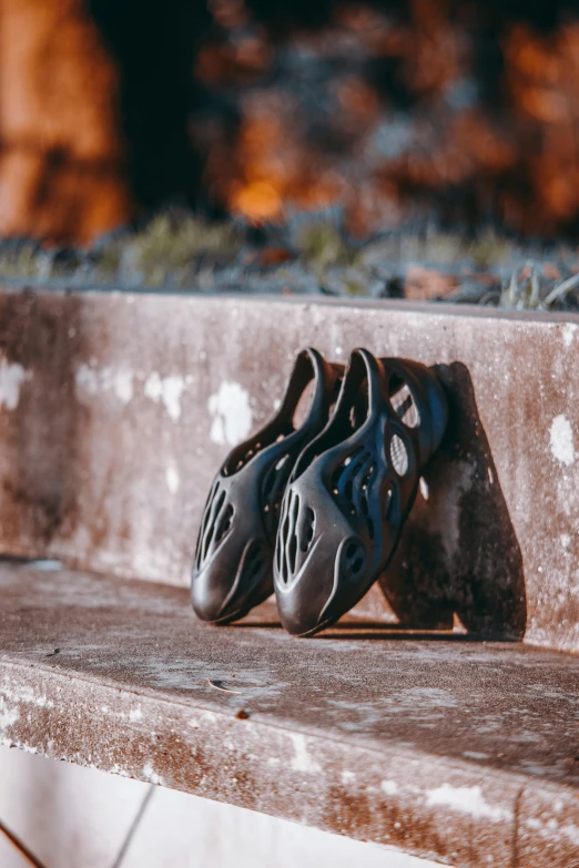 some worn out shoes are lying on a ledge