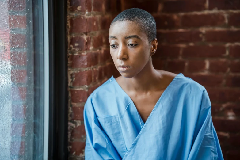 a woman is standing looking out the window