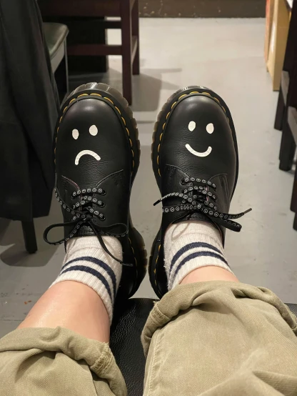someone with smiley face on their shoes and socks