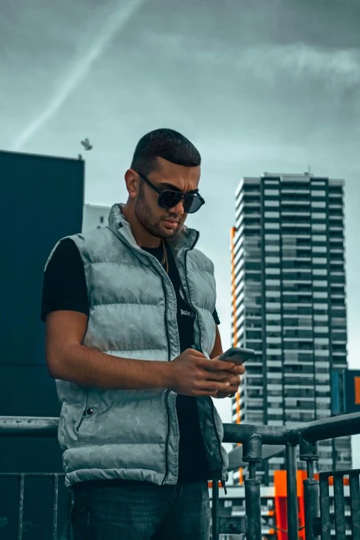 a man wearing sunglasses looking at his cell phone