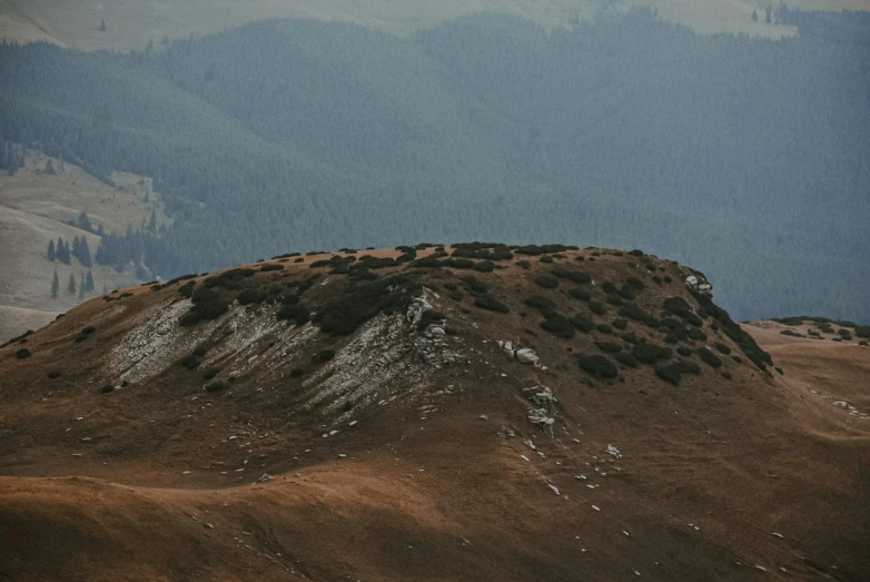 a mountain slope covered in grass and dirt